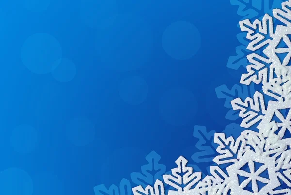 Blauer Hintergrund mit Schneeflocken im Rand. Raum für Text — Stockfoto