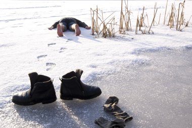 Tired man barefooted to lie on snow clipart