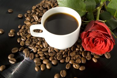 Cup with coffee on grains of coffee with rose clipart