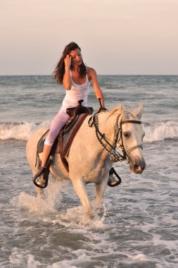 Woman and horse in the sea clipart