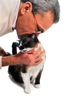 A man kissing his siamese cat in front of a white background clipart