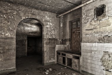 Interior shot of an old and decaying kitchen clipart