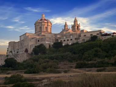 The beautiful city of Mdina gently kissed by the last rays of the sun on a summer's day clipart