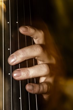 Detail shot of a bassist's fingers on an upright bass fretless neck clipart