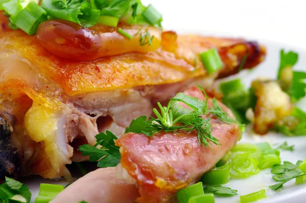 stock image Grilled chicken on a white plate with vegetables on the background.