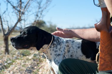 A hunter and his dog, a strong parntership clipart