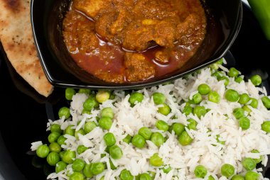 Chicken Madras curry served with rice and naan bread clipart