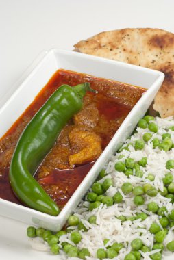 Chicken Madras curry served with rice and naan bread clipart