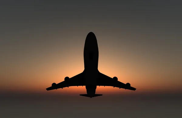 Décollage de l'avion au coucher du soleil Photo De Stock