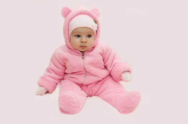 Baby girl in pink snowsuit — Stock Photo, Image