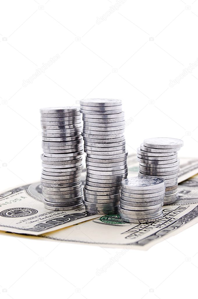 Pile of silver coins on dollar bnknotes
