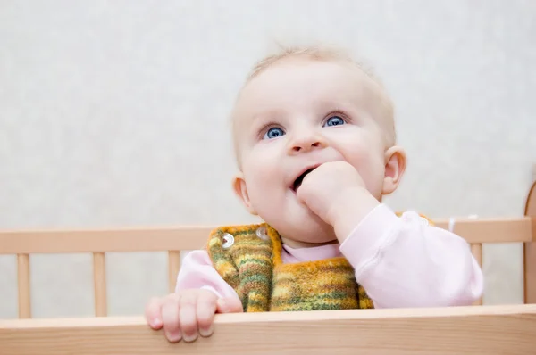 Curious baby with finger in mouth — Stock Photo, Image