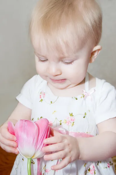 Baby girl with tulip — Stock Photo, Image