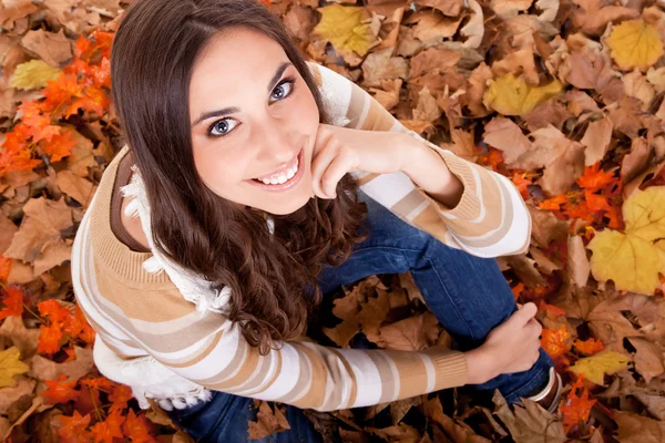 Primo piano di una donna in foglie di autunno — Foto Stock