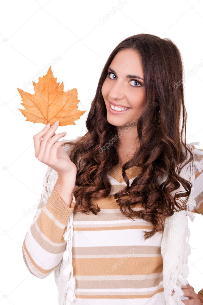 Happy attractive autumn woman holding leaf