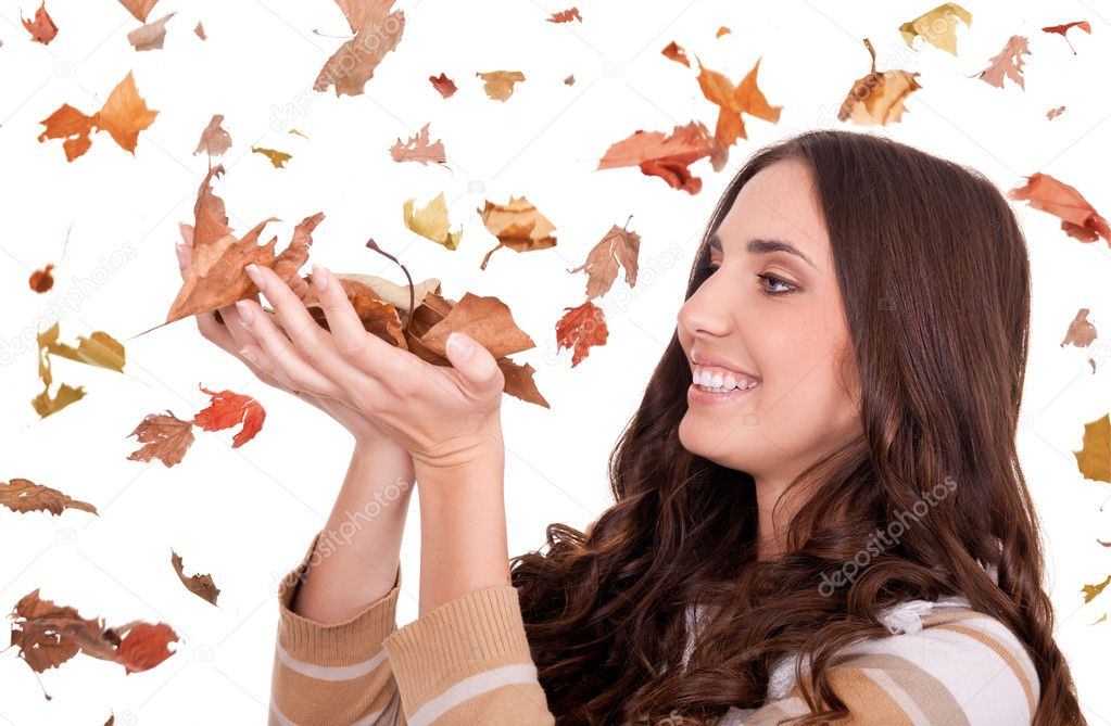 Beautiful woman holding autumn leaves