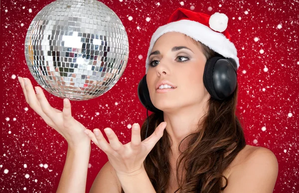 Party in snow, disco ball and girl with santa hat — Stock Photo, Image
