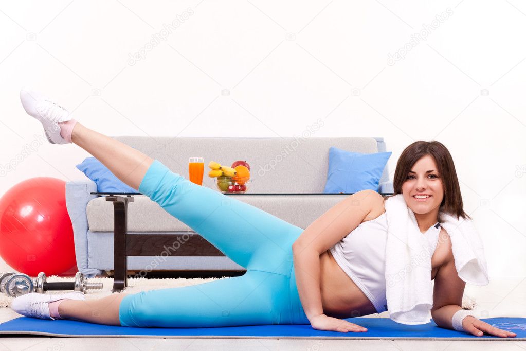 Young teenage girl is exercising in her apartment