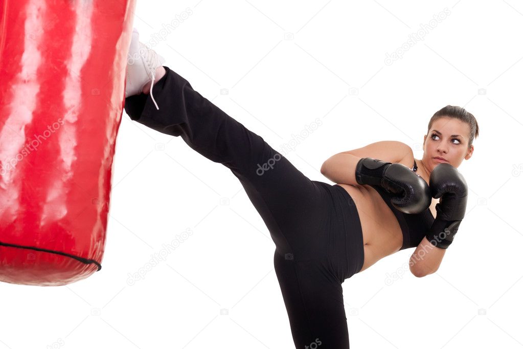 Woman kick a punching bag