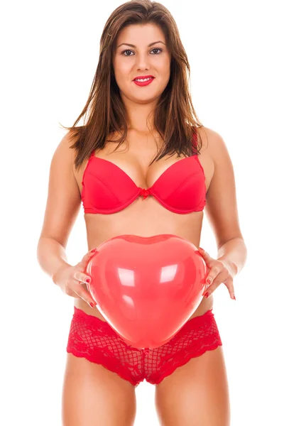 Woman in lingerie holding heart balloon — Stock Photo, Image
