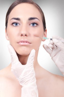 Woman having a collagen or botox injection clipart