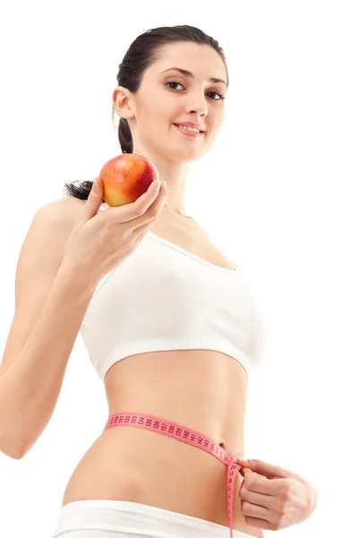 Kobieta z jabłko i centymetrem — Zdjęcie stockowe