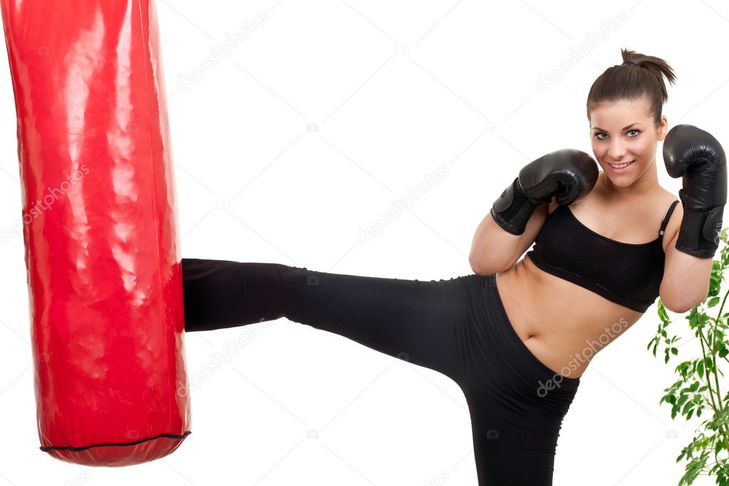 Female boxer kicking punching bag