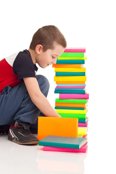Boy playing with books — Stock Photo, Image