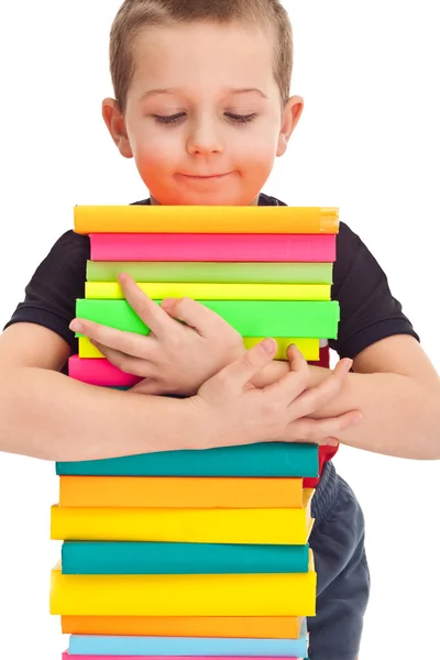 Malý chlapec drží Stoh knih — Stock fotografie