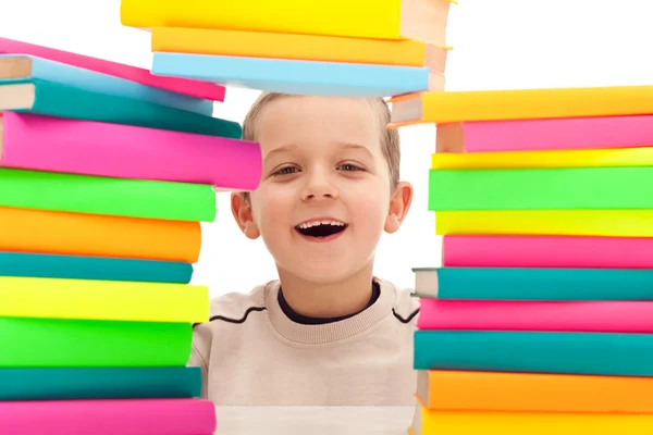 Boy behind pile of books — Stock Photo, Image