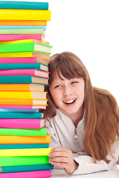 Smiling teenager next to stack books — Stock Photo, Image