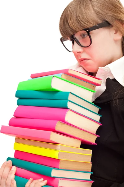 Menina da escola infeliz com livros de cor pilha — Fotografia de Stock