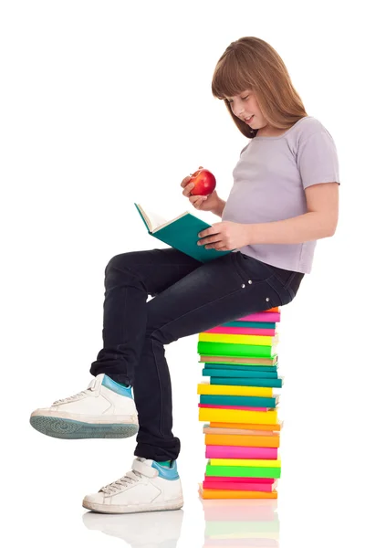 Menina com localização de maçã em livros — Fotografia de Stock