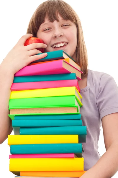 Dívka s kniha zásobníku a apple — Stock fotografie