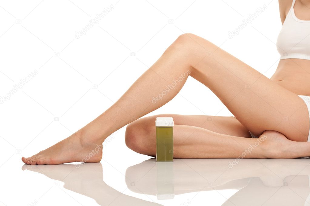 Depilating females legs with wax