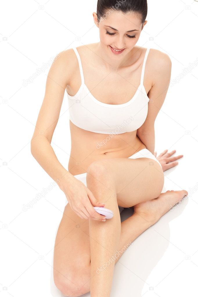 Woman shaving legs - body care