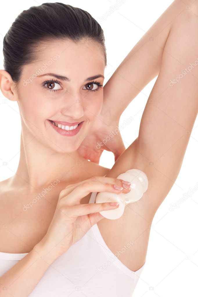 Woman putting deodorant on armpit