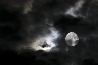 Vortex of eerie white clouds and full moon clipart