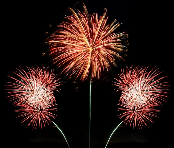 Three bursts of red, white and gold fireworks