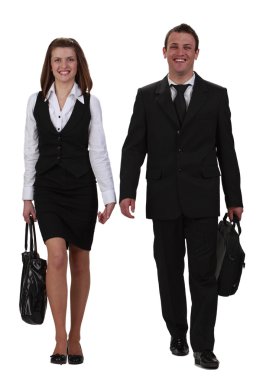 Young happy couple walking together towards the camera,isolated against a white background. clipart