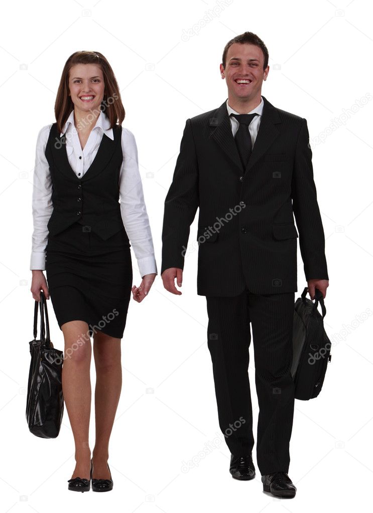 Young happy couple walking together towards the camera,isolated against a white background.