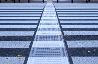 Very low perspective and selective focus of a pedestrian crossing generating an interesting urban abstract. clipart