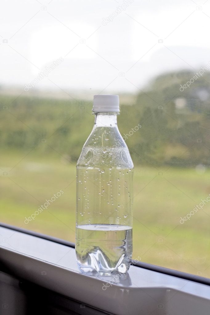 A bottle with mineral water on the jamb in a train in speedy motion.