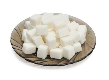 Cubes of sugar on the black plate clipart