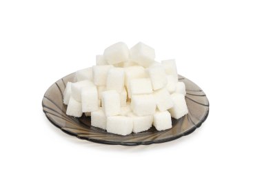 Cubes of sugar on the black plate clipart