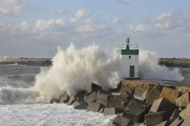 Big wave on a little lighthouse clipart