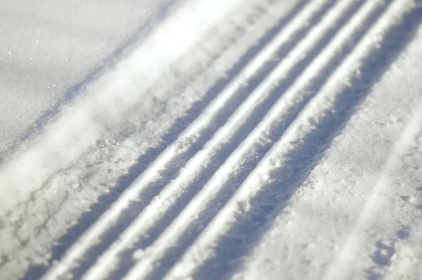 Close-up on a tyre traces in the snow — Stock Photo, Image