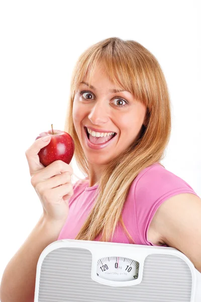 Hermosa mujer sosteniendo una escama y manzana — Foto de Stock