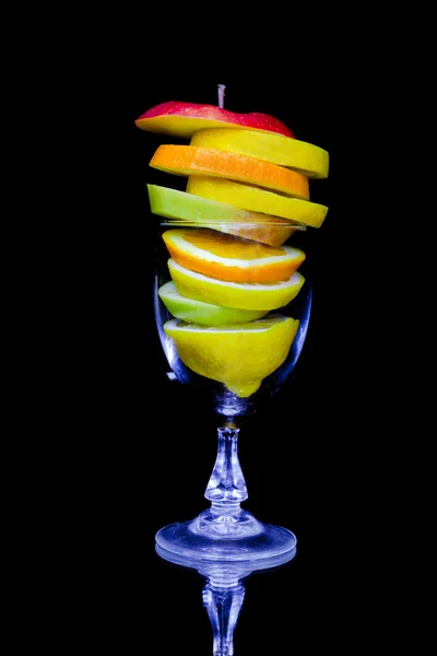 stock image Fruit cocktail composition isolated on black background