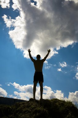 Silhouette of man on sky background. clipart